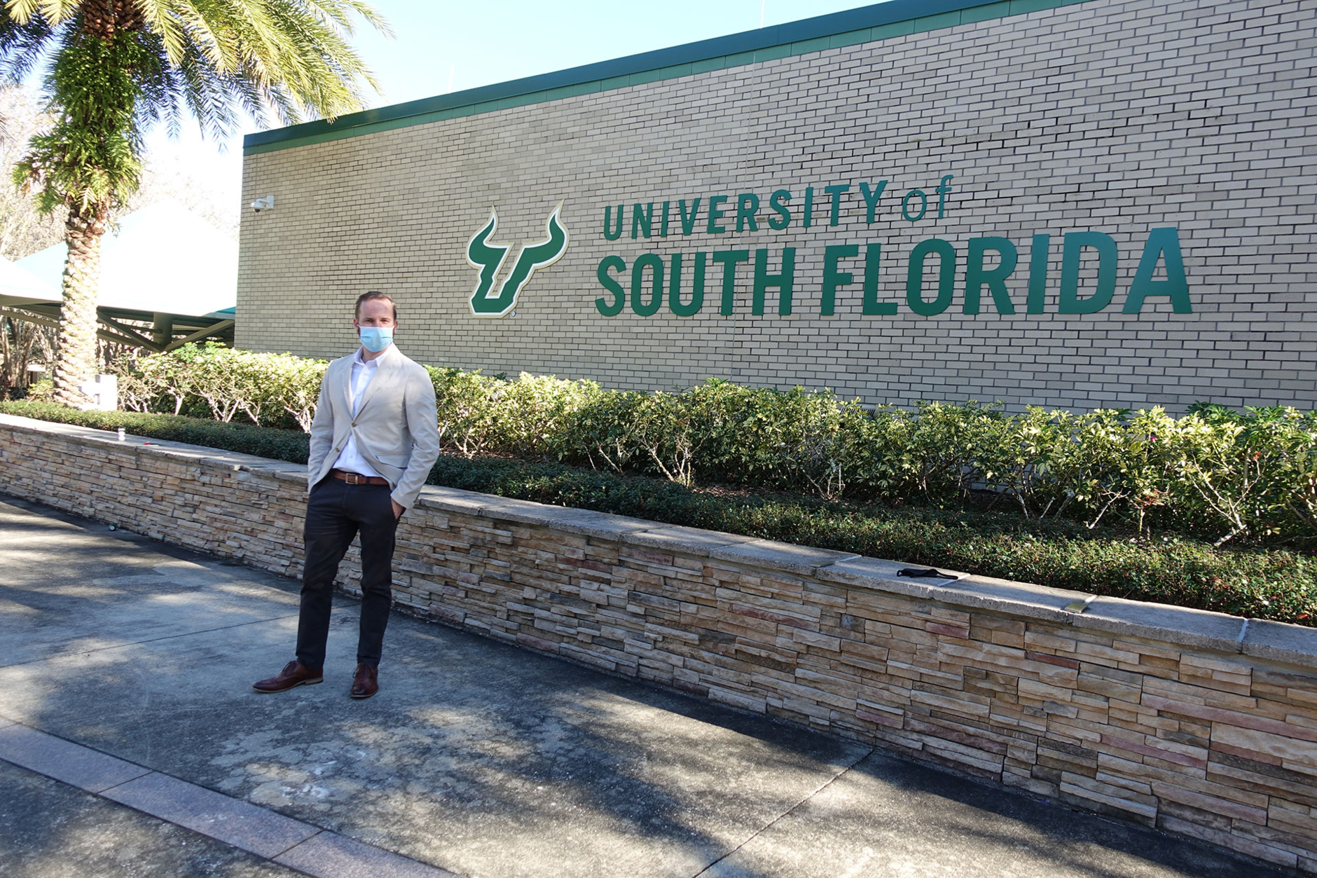 university-of-south-florida-sound-engineer-in-front-of-logo